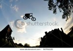 stock-photo-silhouette-of-a-man-doing-a-mountain-bike-jump-56764105.jpg