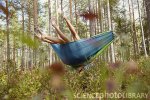F0044774-Women_relaxing_in_hammock_in_forest-SPL.jpg